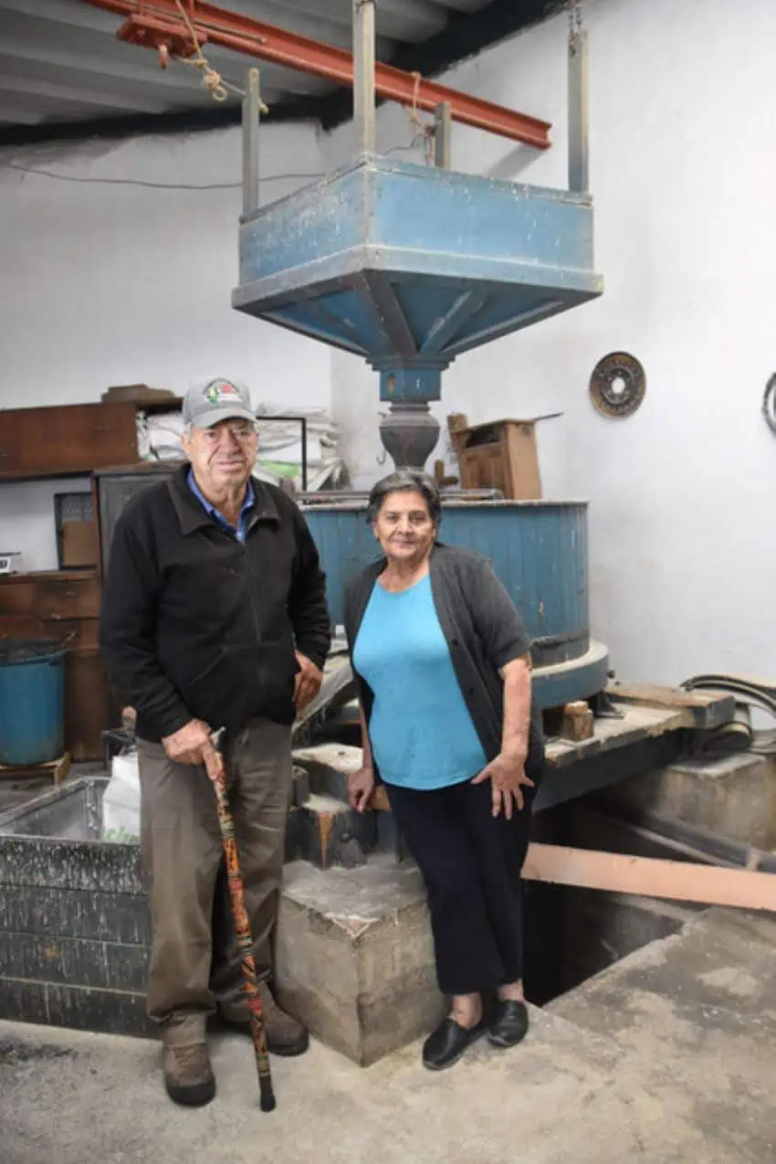 Husband and wife Jacobo Simoni Piloni and Esperanza Sevenello Stefanoni have a machine that grinds corn into the polenta for pintha bread.