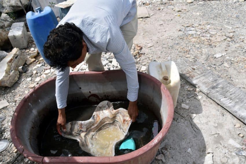 Álvaro Meza Hernández, the owner of the Mezher artisan workshop, rinses clean his finished bowl.