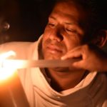 Lighting a candle just before midnight on the Saturday before Easter.