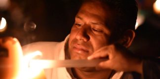 Lighting a candle just before midnight on the Saturday before Easter.