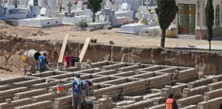 Workers prepare graves for 1,500 anticipated Covid victims in Jalisco last year.