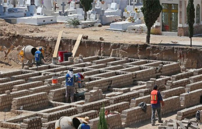 Workers prepare graves for 1,500 anticipated Covid victims in Jalisco last year.