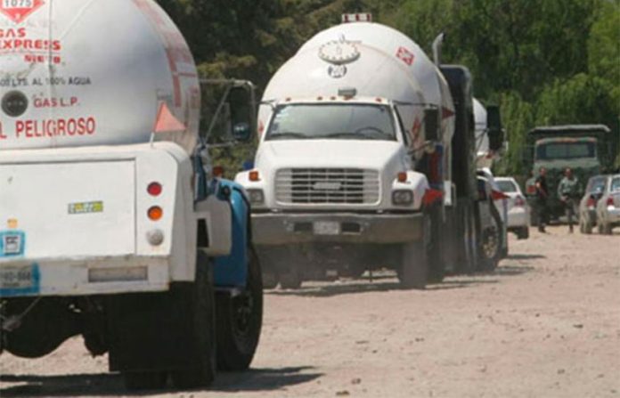 Tanker trucks at the scene of an LP gas pipeline tap.