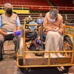 The couple wait for their shots at a Celaya vaccination center.