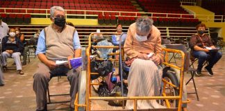 The couple wait for their shots at a Celaya vaccination center.