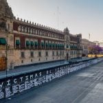 Victims' names adorn metal barrier in front of National Palace.