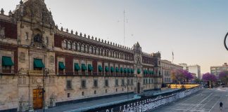 Victims' names adorn metal barrier in front of National Palace.