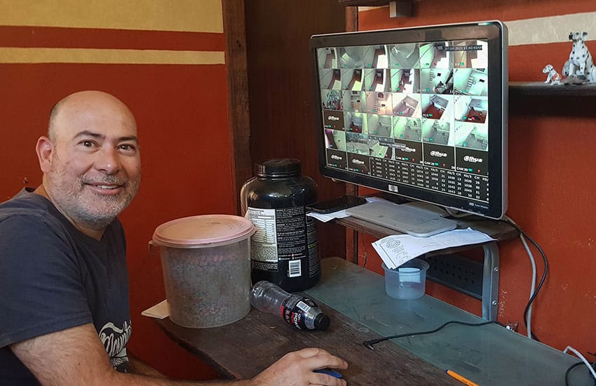 Guillermo "Memo" Ortiz at his computer, where he keep tabs on his doggy guests in their hotel “suites.” Owners can follow along via smartphone.