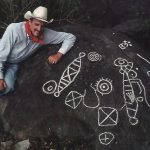 Archaeologist Joseph Mountjoy with examples of Huichol petroglyphs he, with help from National Geographic, documented for exhibit at the Casa Cultura in Mascota.