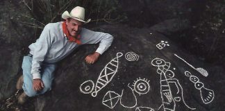 Archaeologist Joseph Mountjoy with examples of Huichol petroglyphs he, with help from National Geographic, documented for exhibit at the Casa Cultura in Mascota.