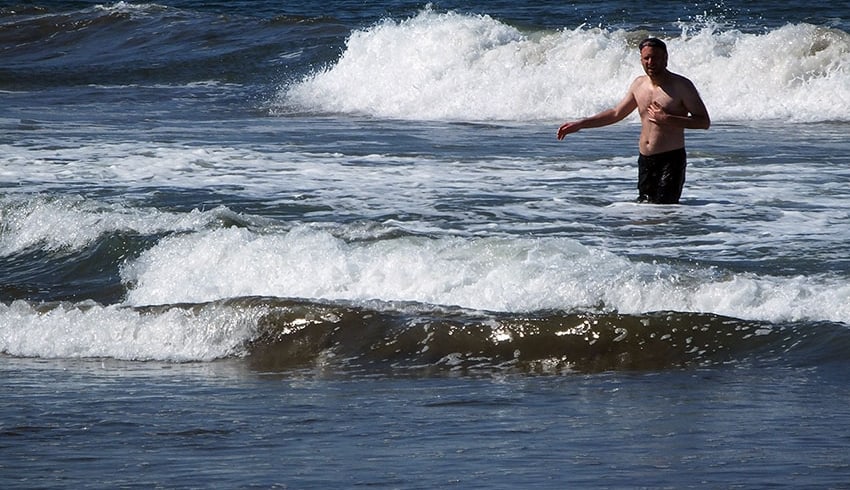 “The surf is great!” says Josh Wolf while testing the waters at Dolphin Beach.