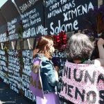 Women in Mexico City writing femicide victims' names onto metal barriers authorities had installed in anticipation of International Women's Day.