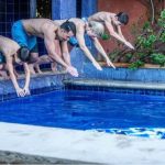 Casa Luna owners Al and Agatha Doerksen daughter Susan (second from left) and her family take an enthusiastic dive in the rental home's tiled pool.