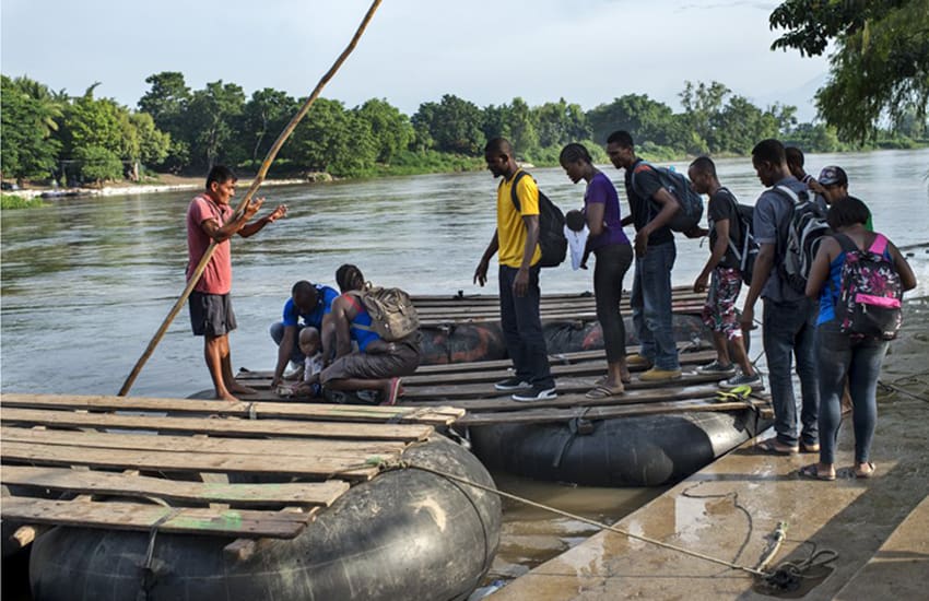 This latest wave of migrants is new, but the problem isn't: Haitian migrants in 2016 crossing the Suchiate River from Guatemala into Chiapas.