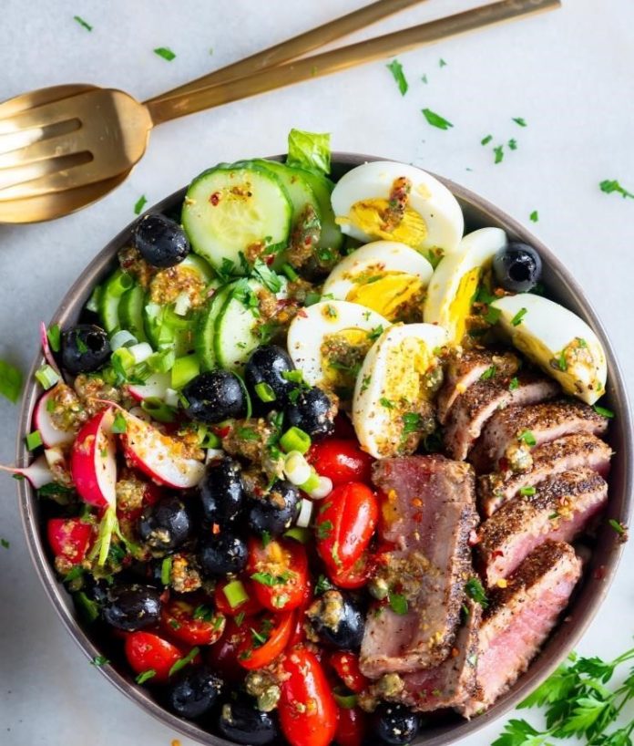 Hard-boiled eggs and tomatoes lend a dash of color to this hearty Nicoise Salad.