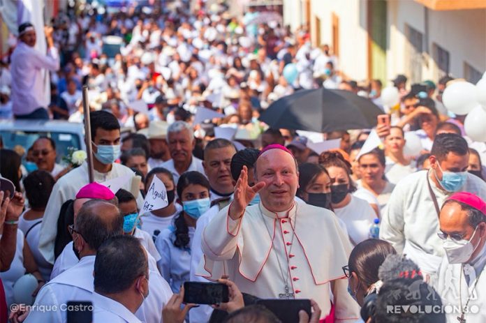 Archbishop Coppola leads a procession Friday through Aguililla, Michoacán.