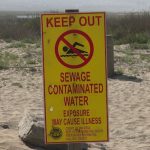 A sign warns Imperial Beach, California residents about water contamination originating from Baja California.