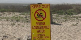 A sign warns Imperial Beach, California residents about water contamination originating from Baja California.