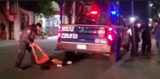 Police arrest a man in Tulum on Wednesday.