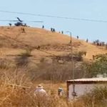 An army helicopter delivers supplies to soldiers camped outside the city of Aguililla.