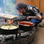 Kicking up the flames on Cubo's wood-fired grill.