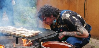 Kicking up the flames on Cubo's wood-fired grill.