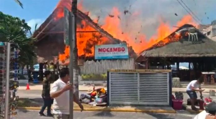 Mocambo restaurant and adjacent businesses burn during Monday's fire.