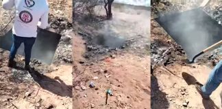 Smoke rises from the pit in which bodies had been deposited.