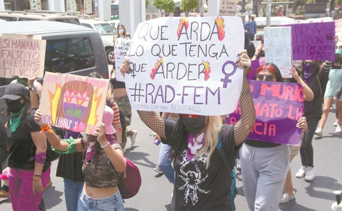Women in Guadalajara protest the alleged murder of a migrant in Tulum.