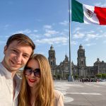 Travel YouTubers Ernestas Tyminas and Darina Karpitskaya on Mexico City's zócalo.