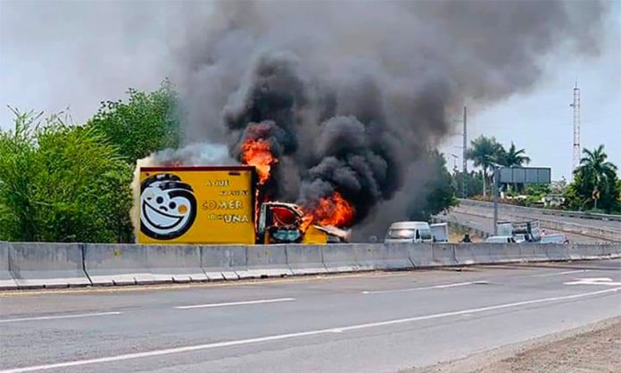 A truck burns on a highway in Michoacán Friday.