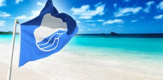 The blue flag flies on a Mexican beach.