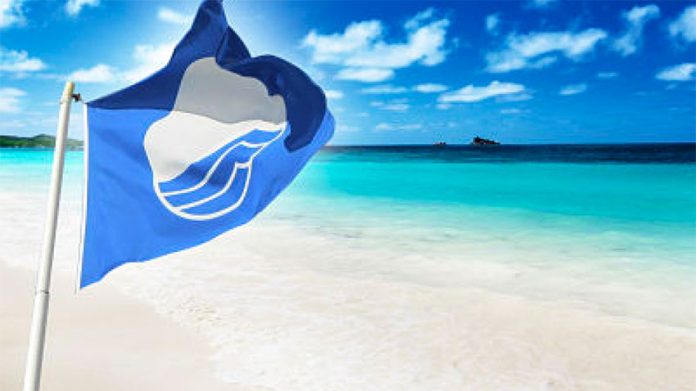 The blue flag flies on a Mexican beach.