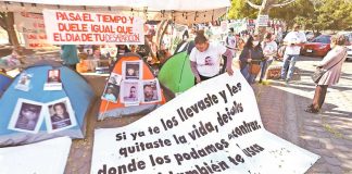 Volunteers at an information booth guide families through the bureaucracy at Jalisco forensic institute.