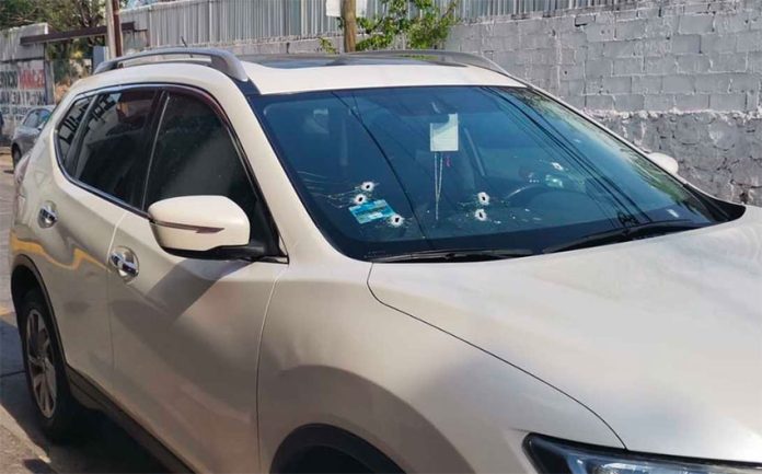 Bullet holes in the windshield of a car in which a candidate for mayor of Acapulco was traveling.