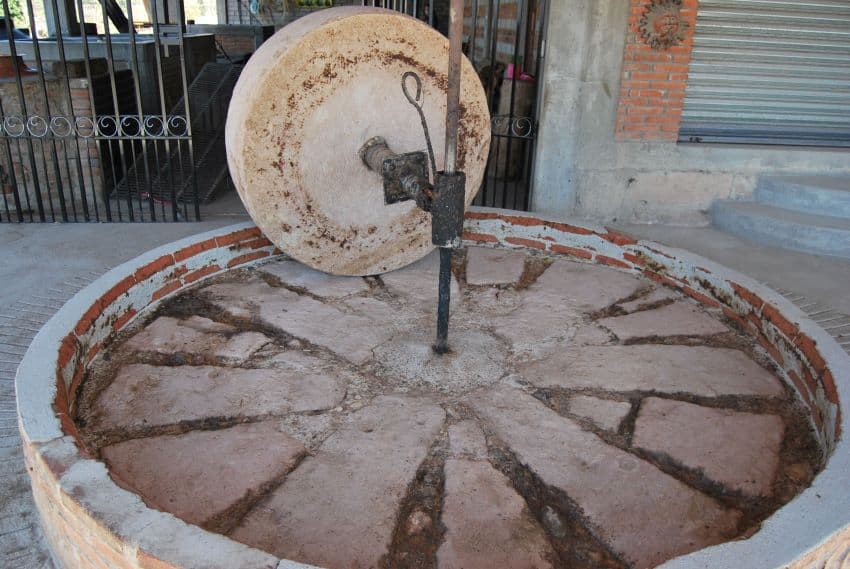 The stone grinding wheel at Hernández's distillery.