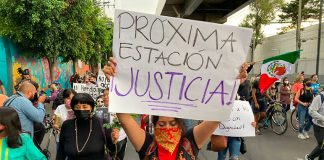'Next station, justice,' reads the sign of a marcher during a protest Friday