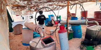 A National Guardsmen stands watch at a meth lab found in Sonora.