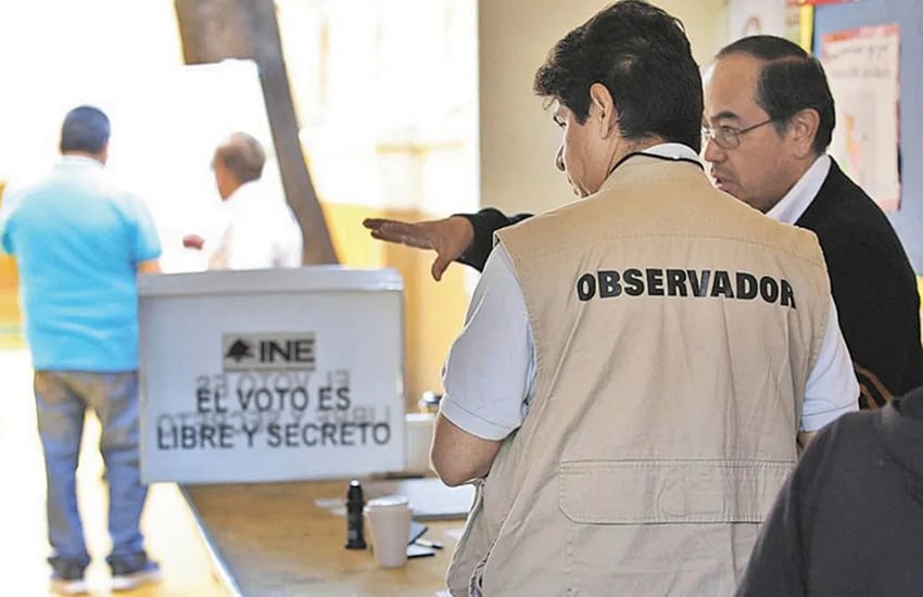 An election observer prepares at a voting station.