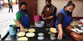 Woman make gorditas in Bernal's historic center.