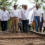 López Obrador walks a section of old railway on the route of the Maya Train.
