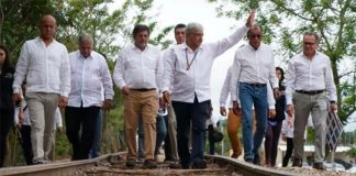 López Obrador walks a section of old railway on the route of the Maya Train.
