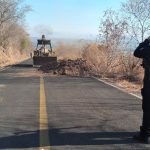 A backhoe clears a blockade earlier this year in Aguililla.