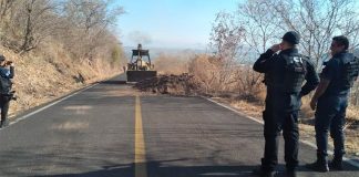 A backhoe clears a blockade earlier this year in Aguililla.