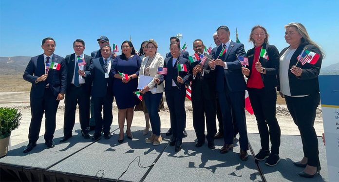 Mexican and US officials celebrating signing of agreement on Monday.