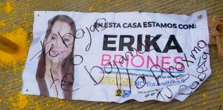 A handwritten message on a campaign leaflet warns that if Briones doesn't step down, her head will be next.