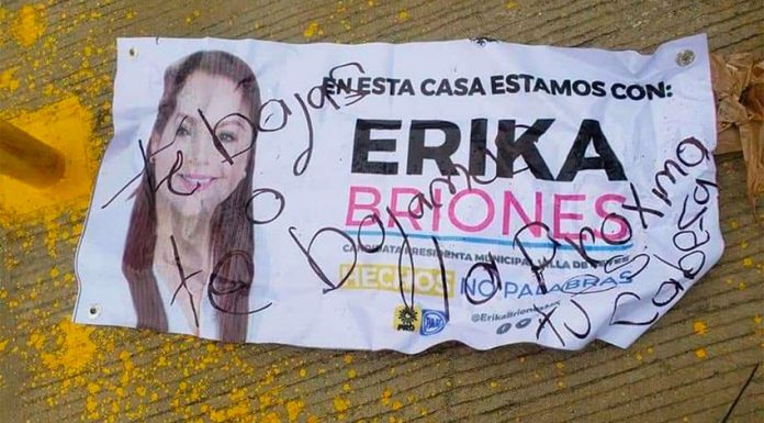 A handwritten message on a campaign leaflet warns that if Briones doesn't step down, her head will be next.