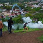 Citizens lob firecrackers and stones at the army's helicopter landing pad in Aguililla.