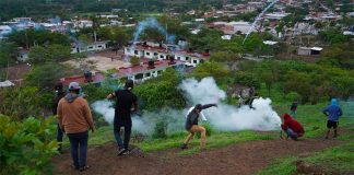 Citizens lob firecrackers and stones at the army's helicopter landing pad in Aguililla.