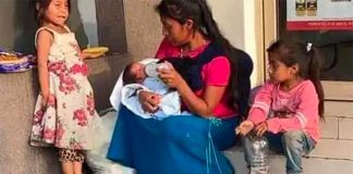 The young mother feeds the baby that was left in her care in downtown Monterrery.